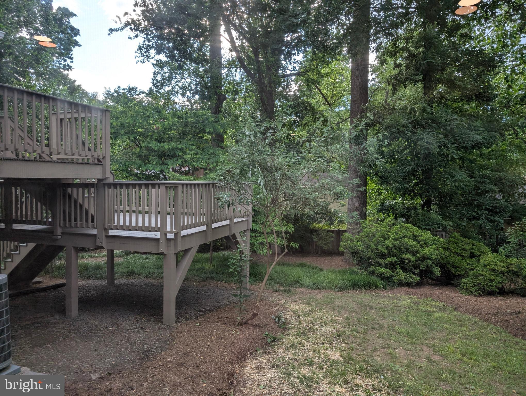9510 Clement Road Silver Spring, MD 20910 - Photo 39 of 80 a view of a wooden deck with chairs and a yard
