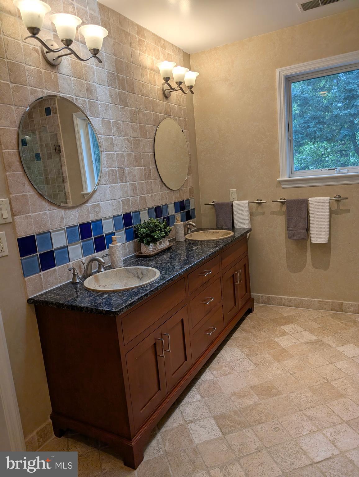 9510 Clement Road Silver Spring, MD 20910 - Photo 53 of 80 a bathroom with a double vanity sink and a mirror