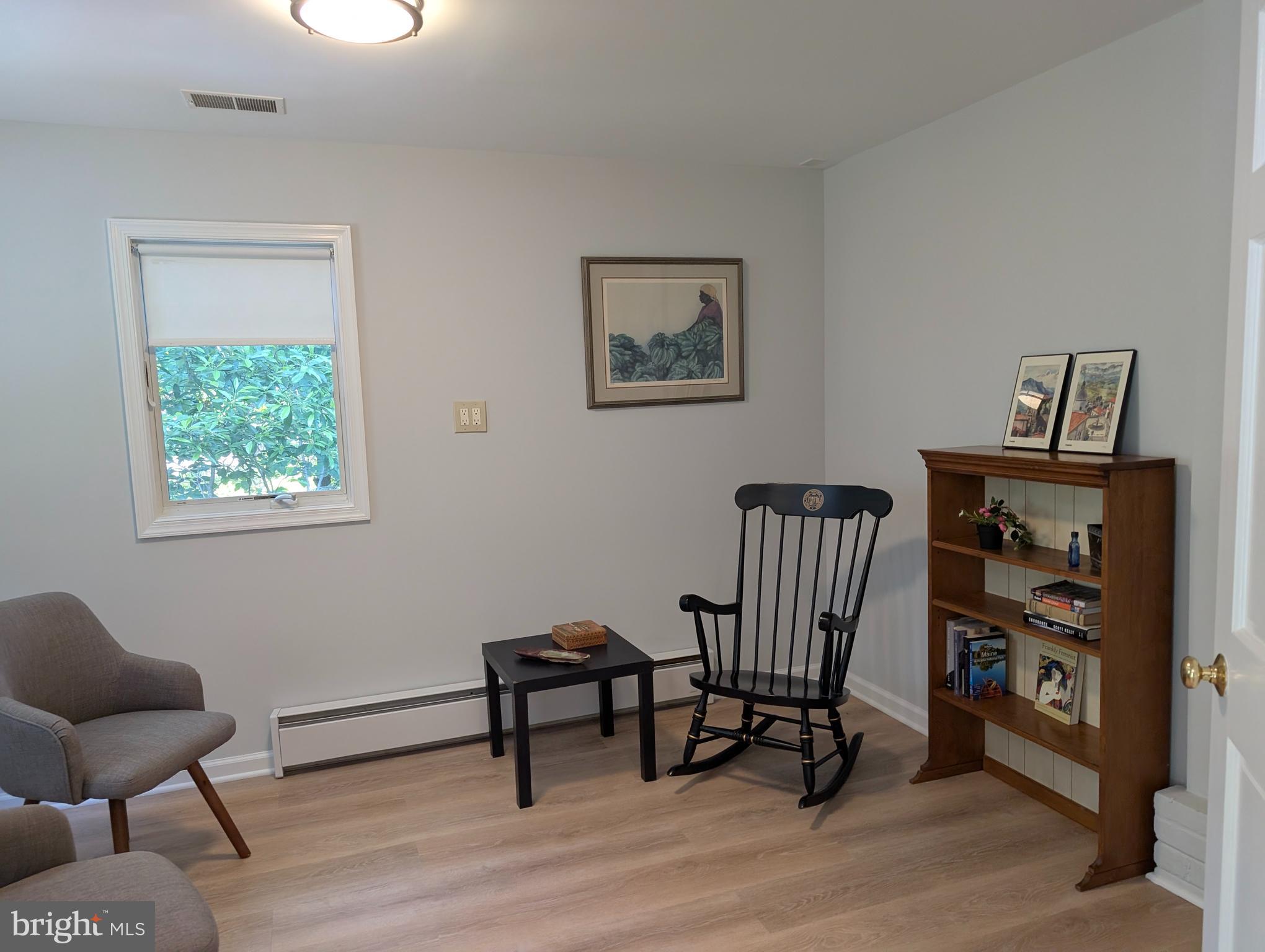9510 Clement Road Silver Spring, MD 20910 - Photo 63 of 80 a view of a workspace with furniture and a wooden floor