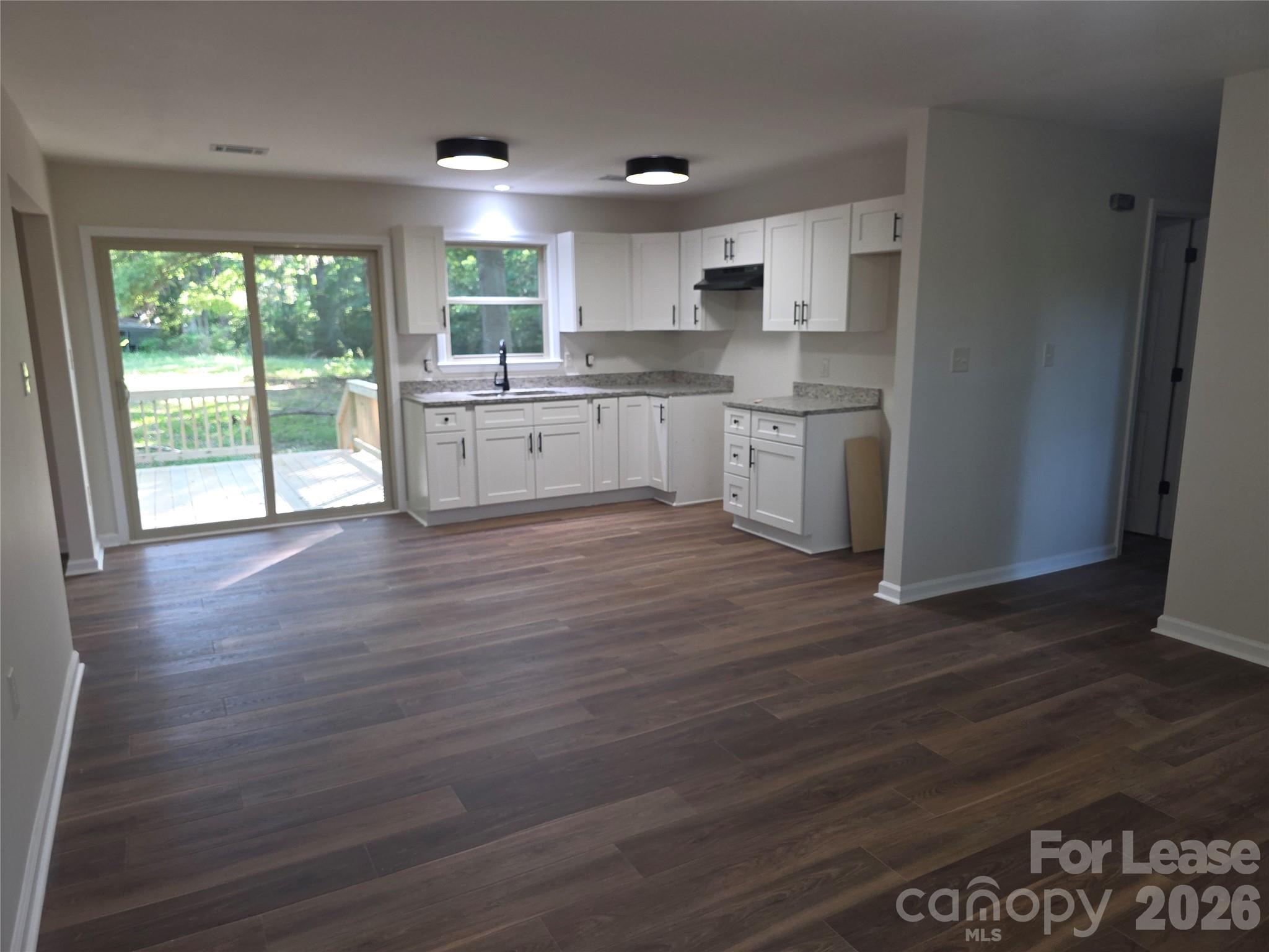 5710 Unionville Road Monroe, NC 28110 - Photo 7 of 18 a kitchen with stainless steel appliances granite countertop a stove a sink and a refrigerator