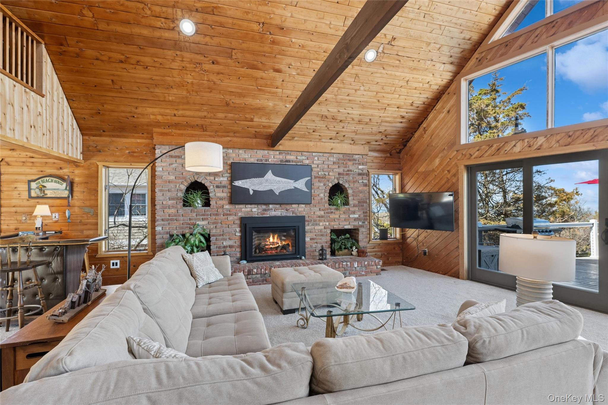 171 Harbor Beach Road Mount Sinai, NY 11766 - Photo 12 of 43 a living room with furniture and a fireplace