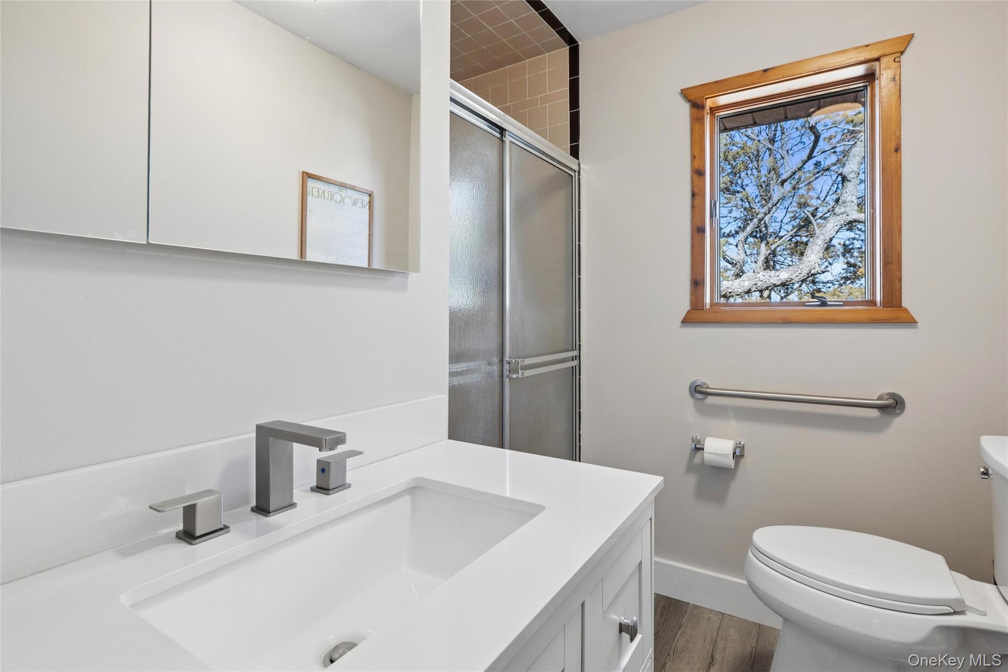 171 Harbor Beach Road Mount Sinai, NY 11766 - Photo 22 of 43 a bathroom with a sink a toilet and mirror