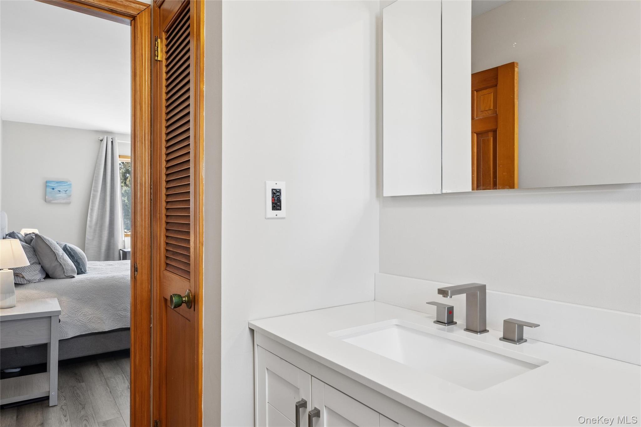 171 Harbor Beach Road Mount Sinai, NY 11766 - Photo 23 of 43 a bathroom with a sink and a mirror