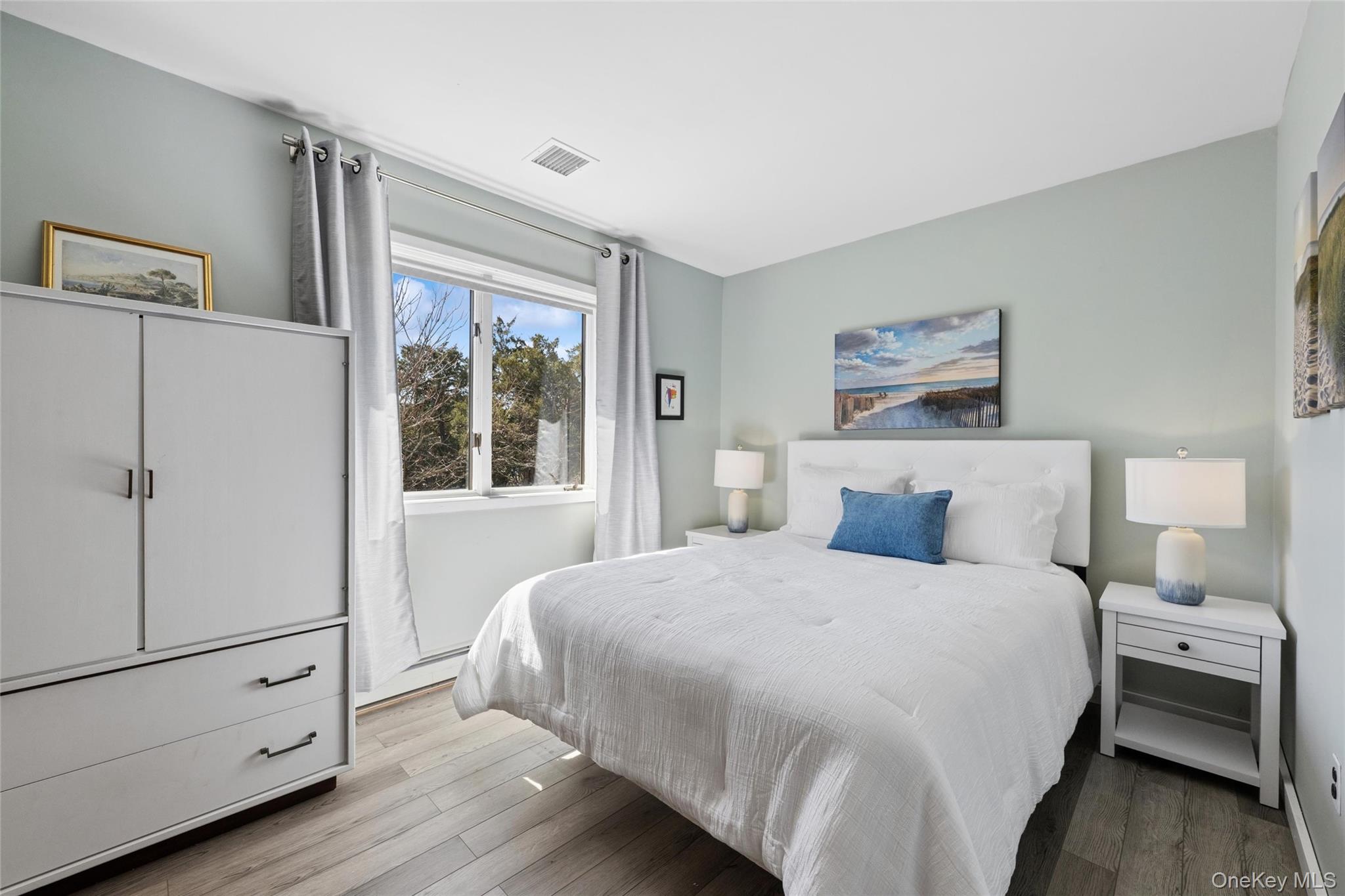 171 Harbor Beach Road Mount Sinai, NY 11766 - Photo 26 of 46 hall way bedroom with triple closet, dresser south facing window
