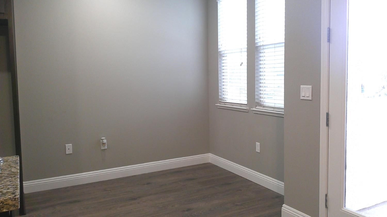 140 Ivy Avenue, Unit 39 Patterson, CA 95363 - Photo 11 of 47 an empty room with wooden floor and windows