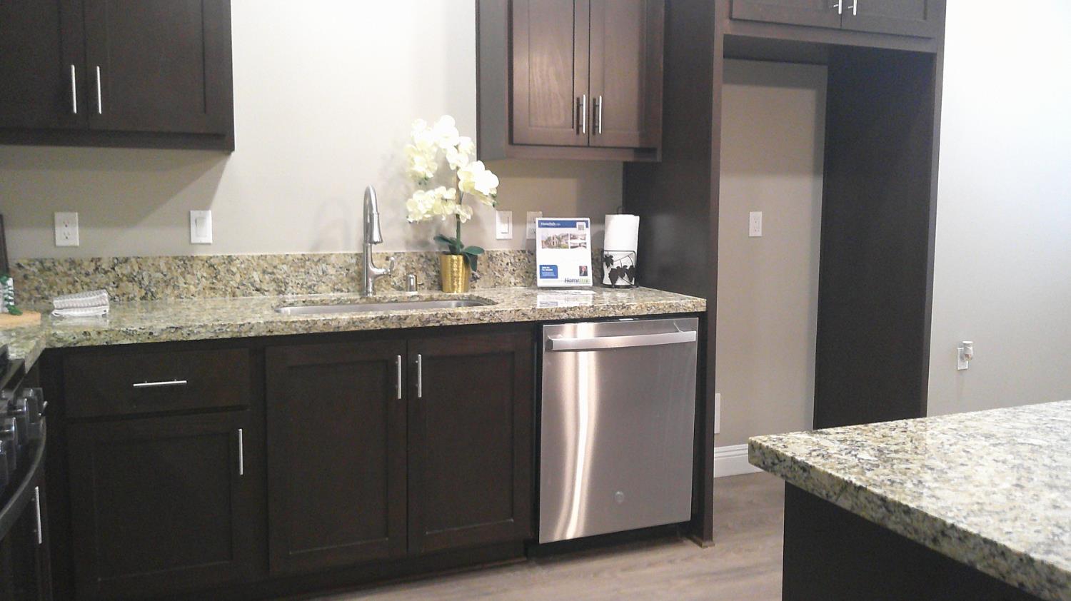 140 Ivy Avenue, Unit 39 Patterson, CA 95363 - Photo 15 of 47 a kitchen with granite countertop a sink a stove and cabinets