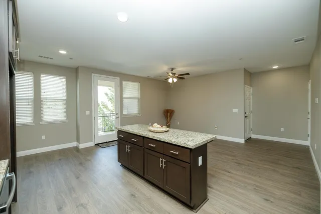 a spacious bathroom with a granite countertop sink a large mirror and shower