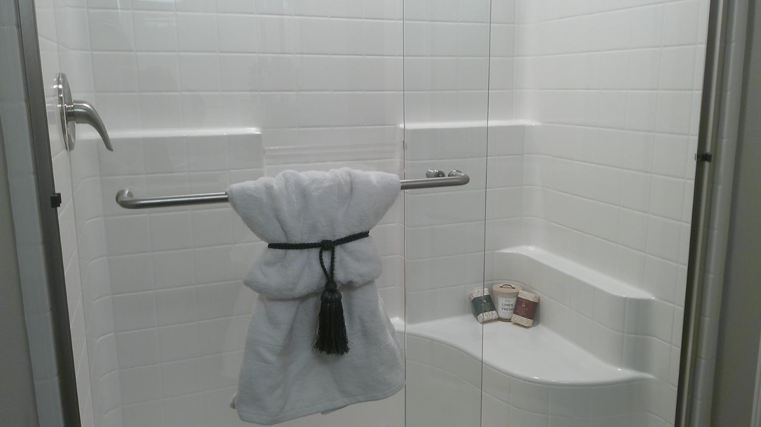 140 Ivy Avenue, Unit 39 Patterson, CA 95363 - Photo 27 of 47 The over-sized double wide stall shower offers new seamless glass shower doors along with a cool shaving seat.