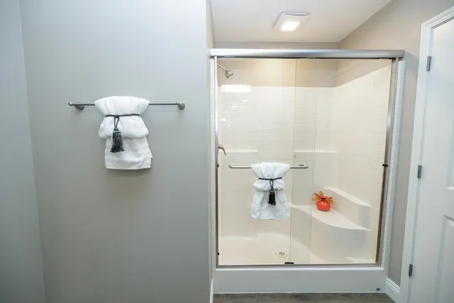 a bathroom with a shower and a sink