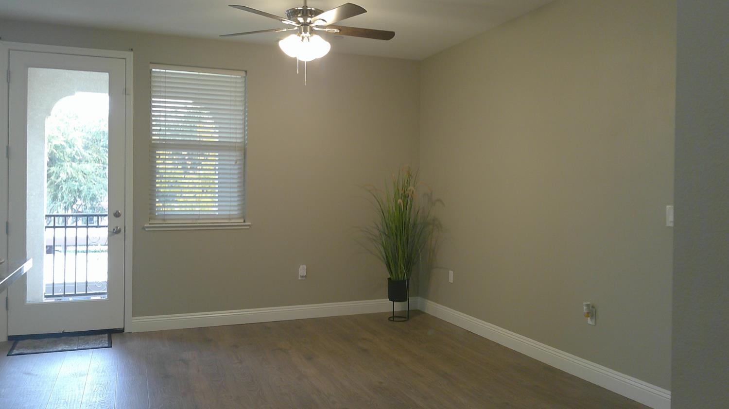 140 Ivy Avenue, Unit 39 Patterson, CA 95363 - Photo 7 of 47 an empty room with wooden floor and windows