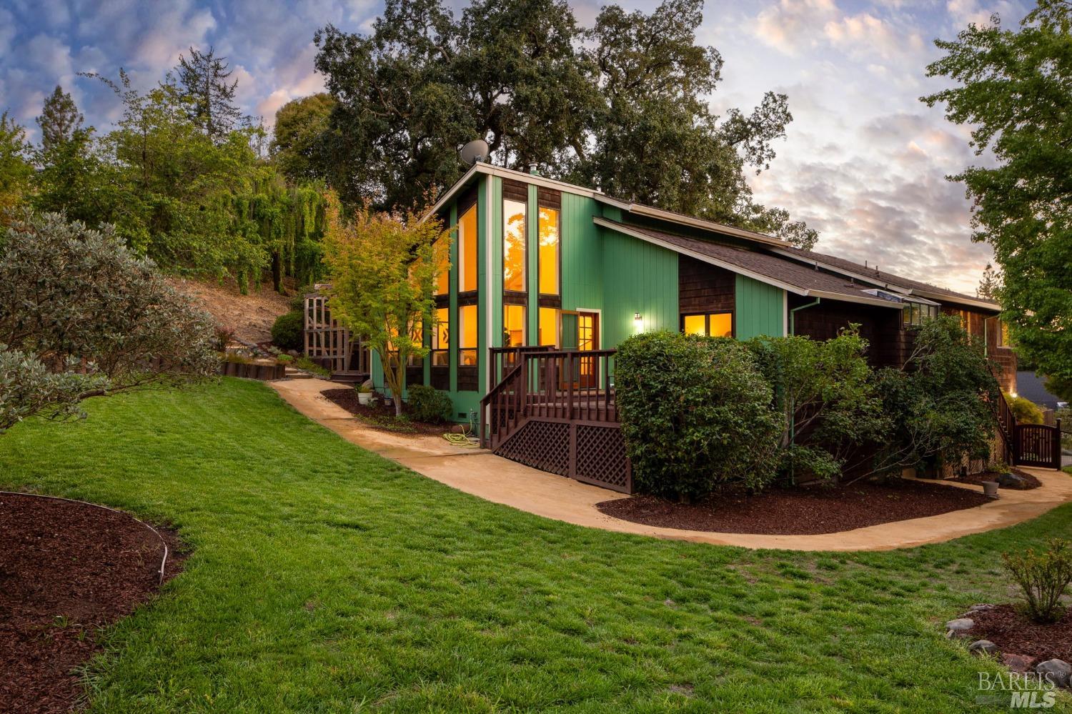 a front view of house with yard and green space