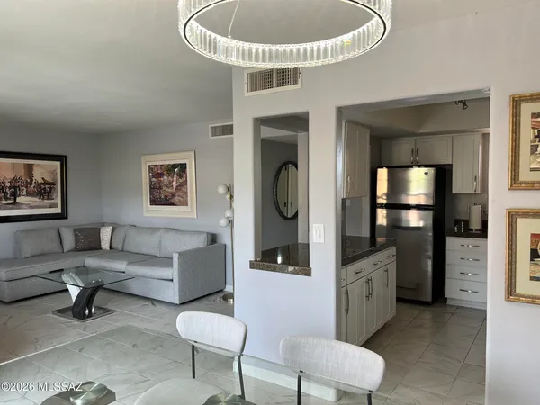 a living room with furniture and a chandelier