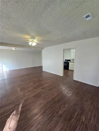 a view of a room with wooden floor and window