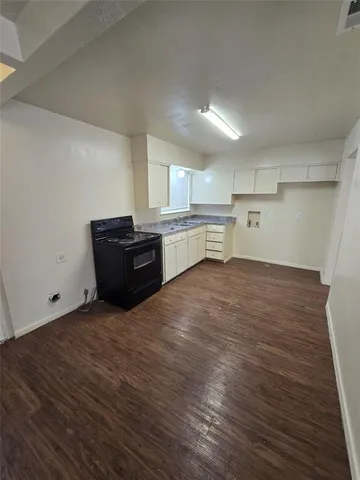 a room with a cabinets and wooden floor
