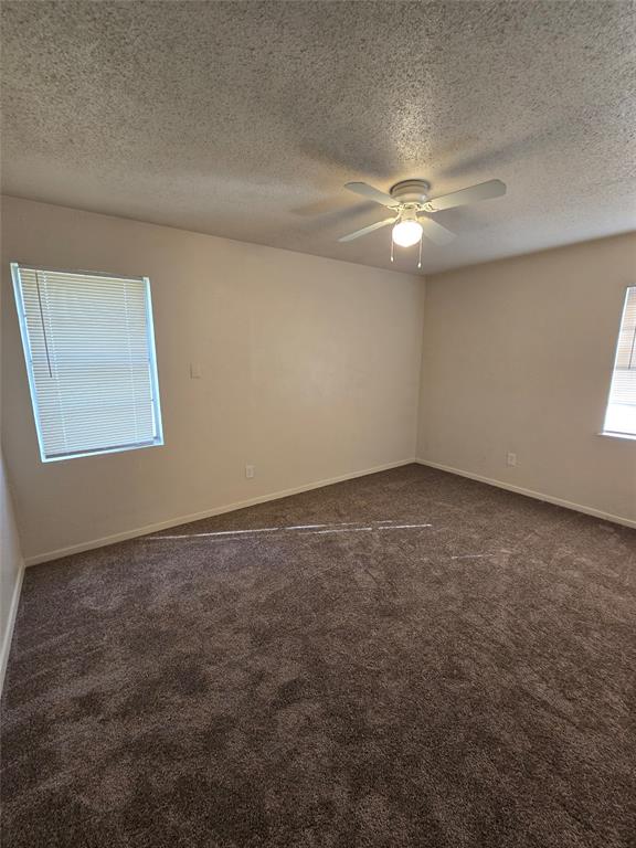 3827 Black Oak Drive Dallas, TX 75241 - Photo 8 of 11 an empty room with a window and ceiling fan
