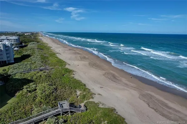 a view of an ocean beach and city