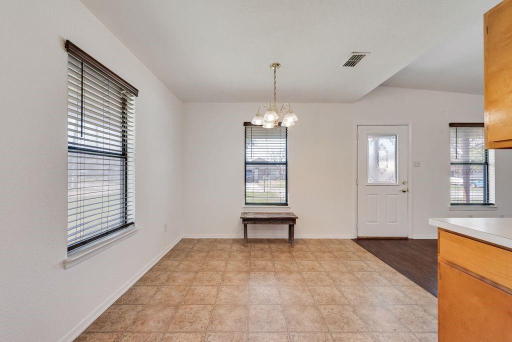 301 Lipscomb Street Cleburne, TX 76031 - Photo 7 of 21 a view of an empty room with a window