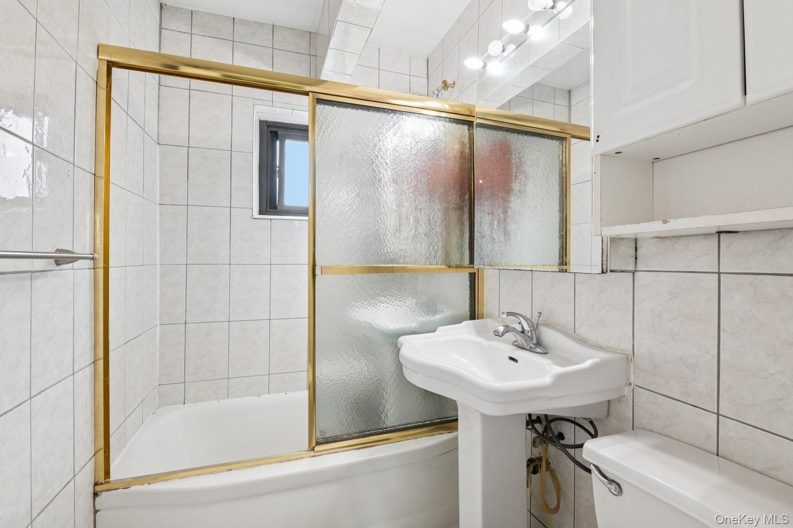 87-30 204th Street, Unit A78 Queens, NY 11423 - Photo 11 of 14 a bathroom with a sink a toilet and shower