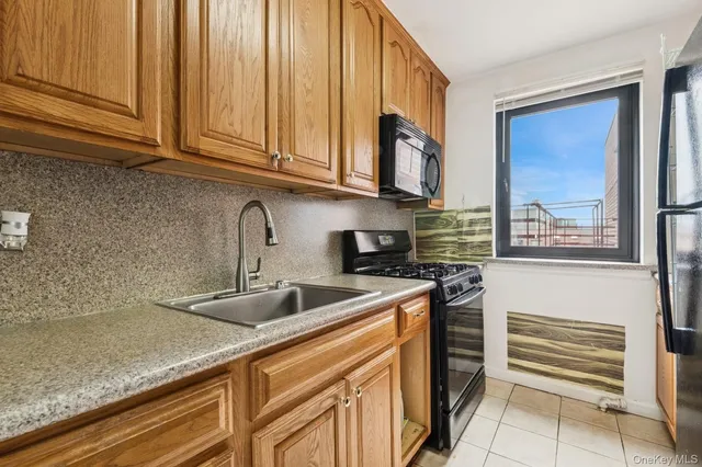 a kitchen with stainless steel appliances granite countertop a sink and a microwave