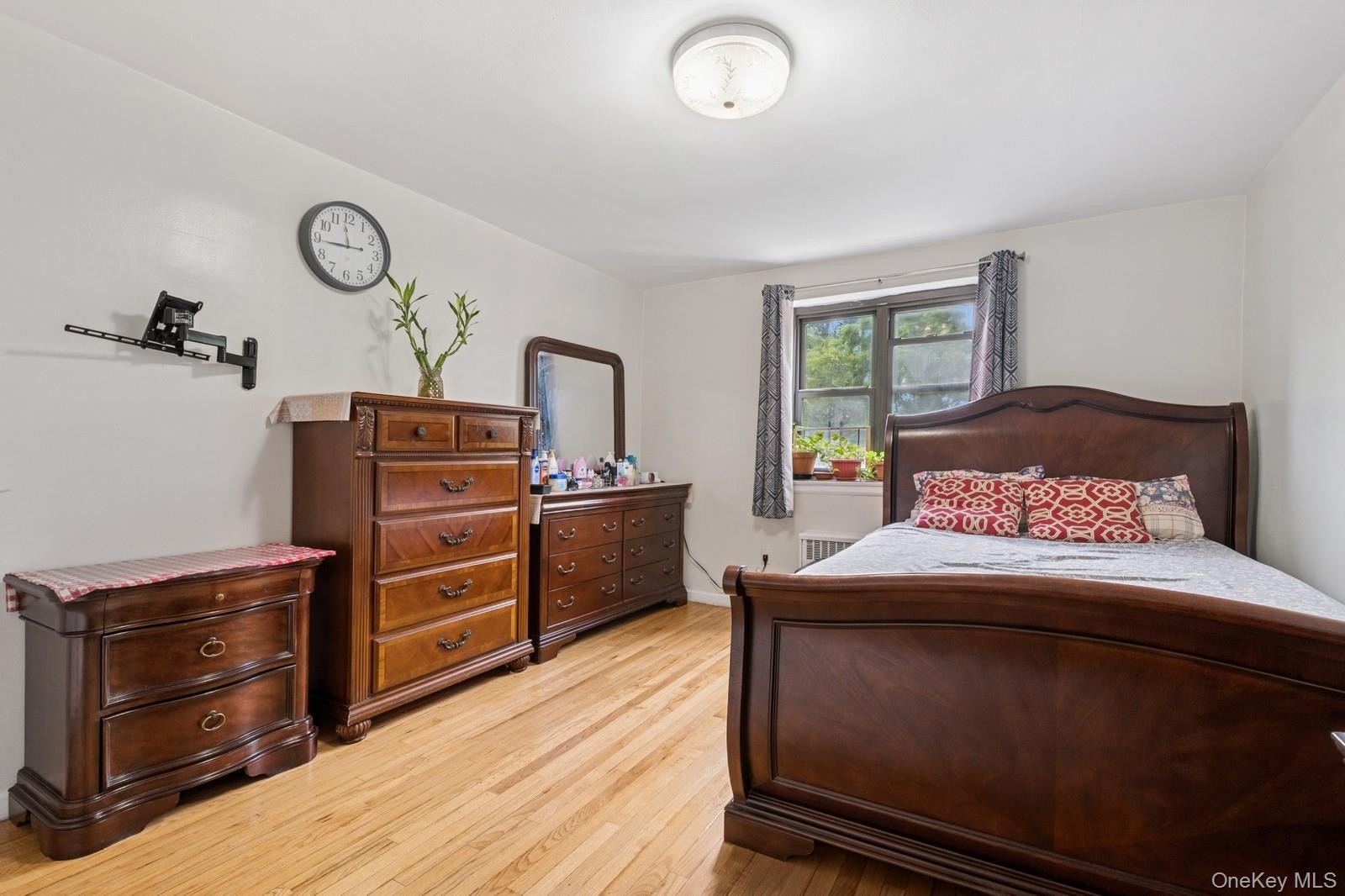 87-30 204th Street, Unit A78 Queens, NY 11423 - Photo 7 of 14 a bedroom with a bed and a dresser