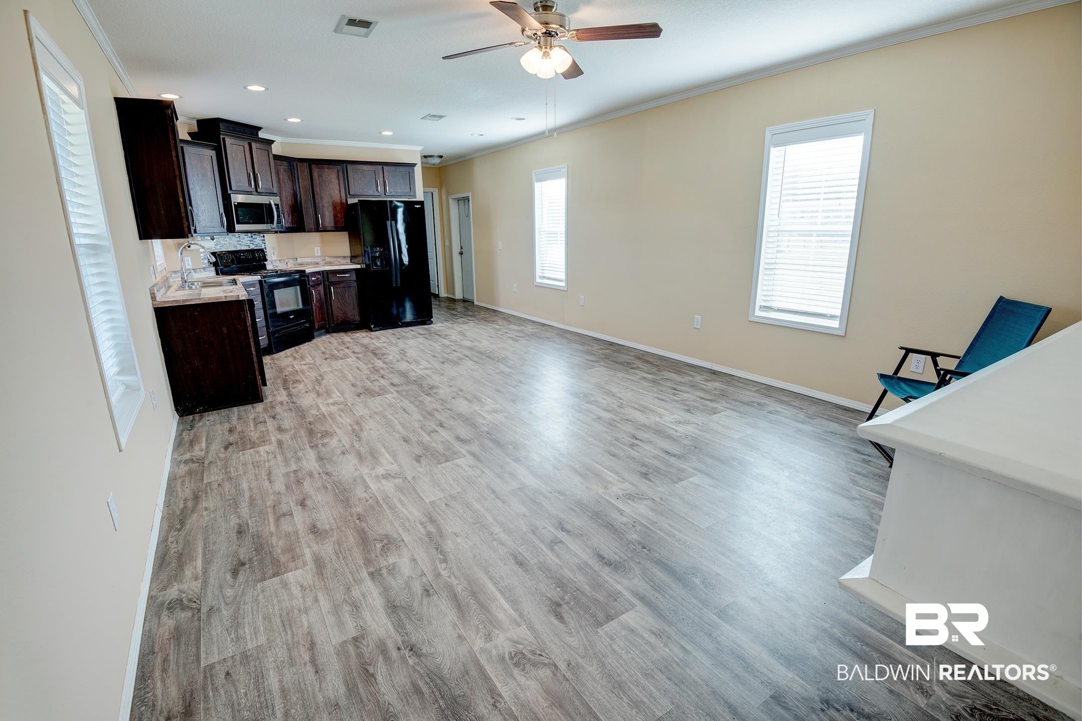 21859 West Side Loop Silverhill, AL 36576 - Photo 12 of 24 Kitchen featuring light wood-type flooring, black appliances, and plenty of natural light
