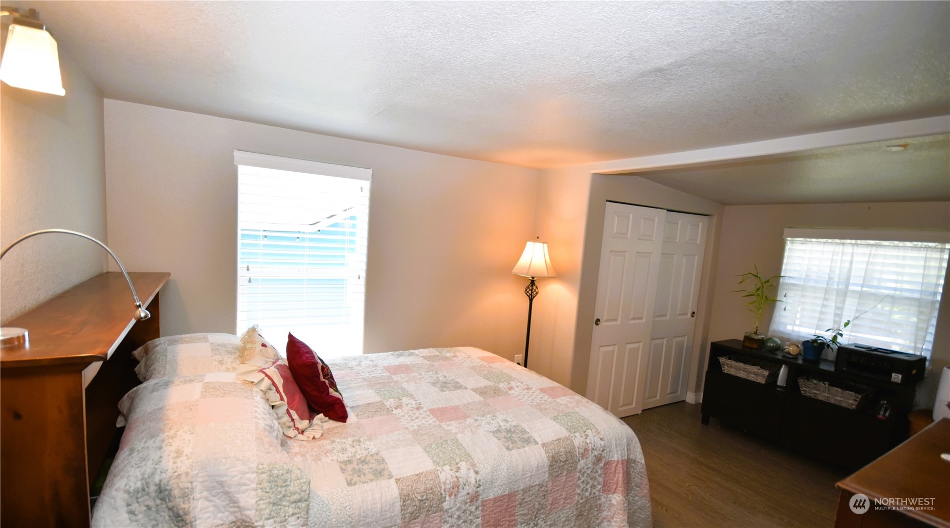 8124 East Daniels Loop Port Orchard, WA 98366 - Photo 16 of 24 a bedroom with a bed and wooden floor