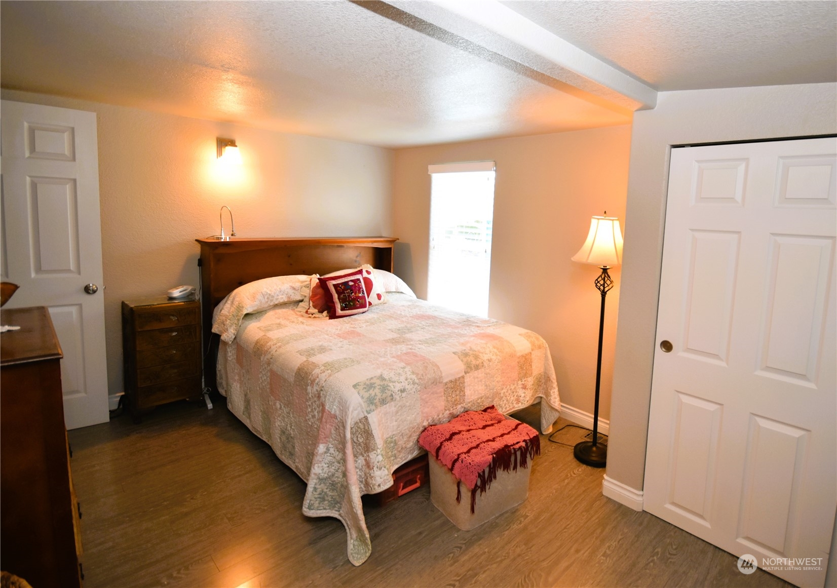 8124 East Daniels Loop Port Orchard, WA 98366 - Photo 17 of 24 a bed sitting in a bedroom next to a window