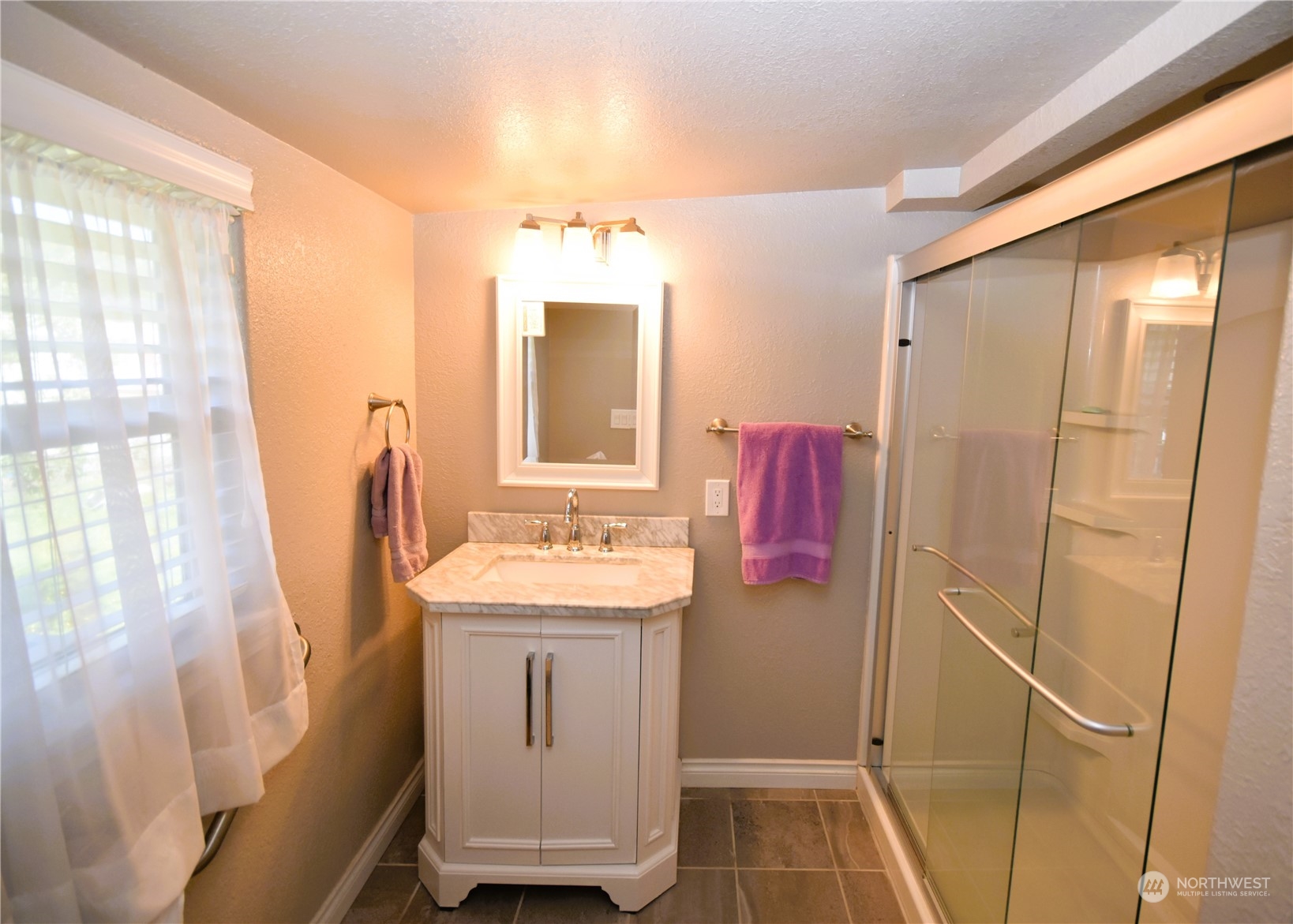 8124 East Daniels Loop Port Orchard, WA 98366 - Photo 19 of 24 a bathroom with a sink toilet and shower