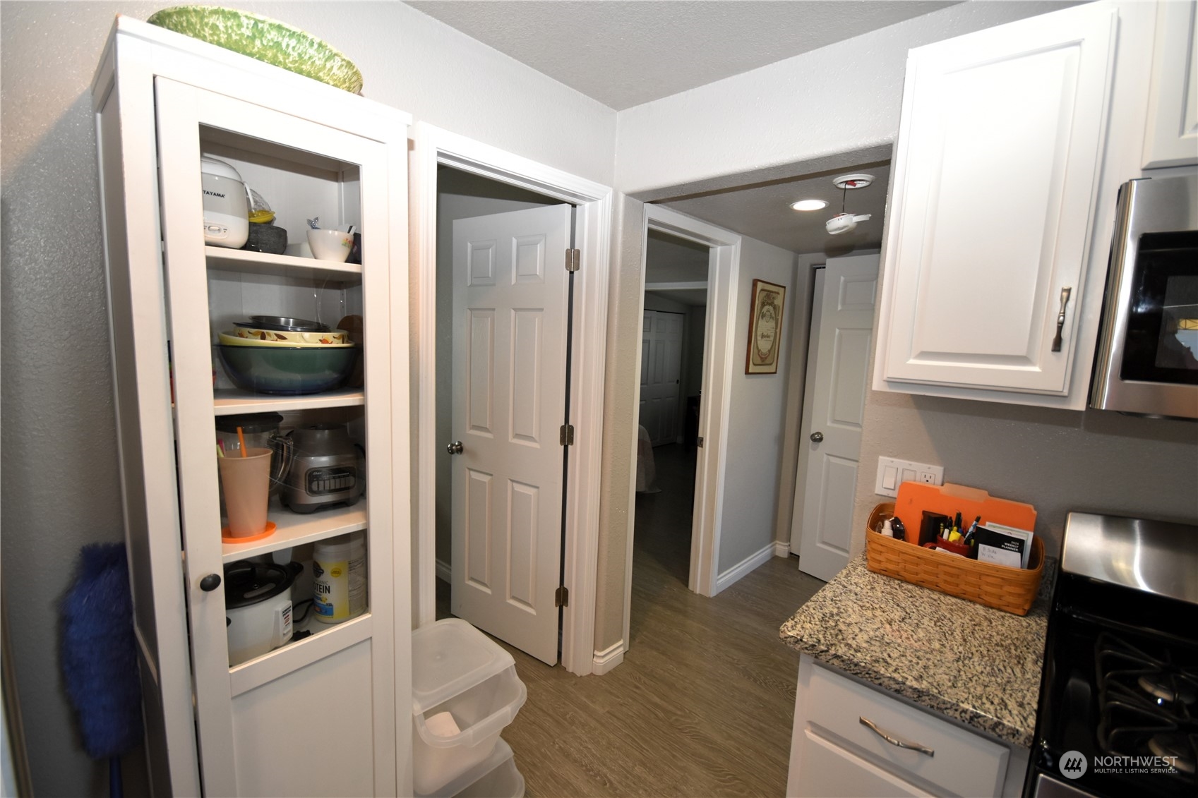 8124 East Daniels Loop Port Orchard, WA 98366 - Photo 9 of 24 an entryway with wooden floor and cabinets