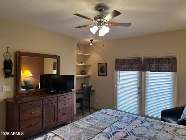a bedroom with a bed and a flat screen tv
