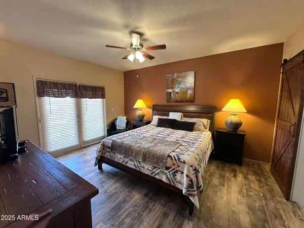 a bedroom with bed and window with lamp