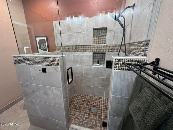 a bathroom with a sink a mirror and shower