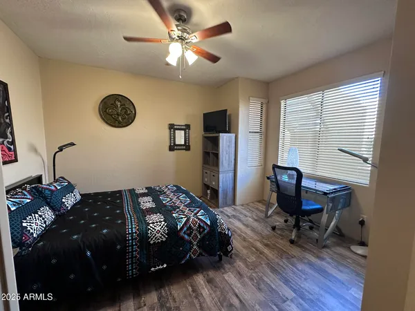 a bedroom with a bed window and a desk