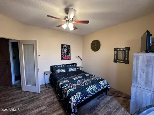 a bedroom with a bed and wooden floor