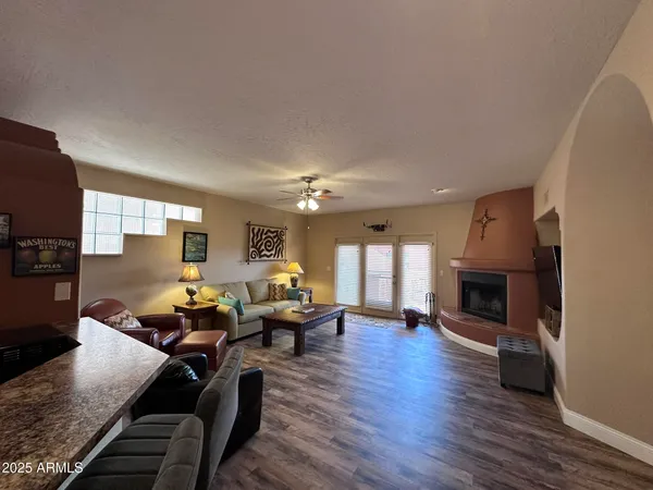 a living room with fireplace furniture and a wooden floor