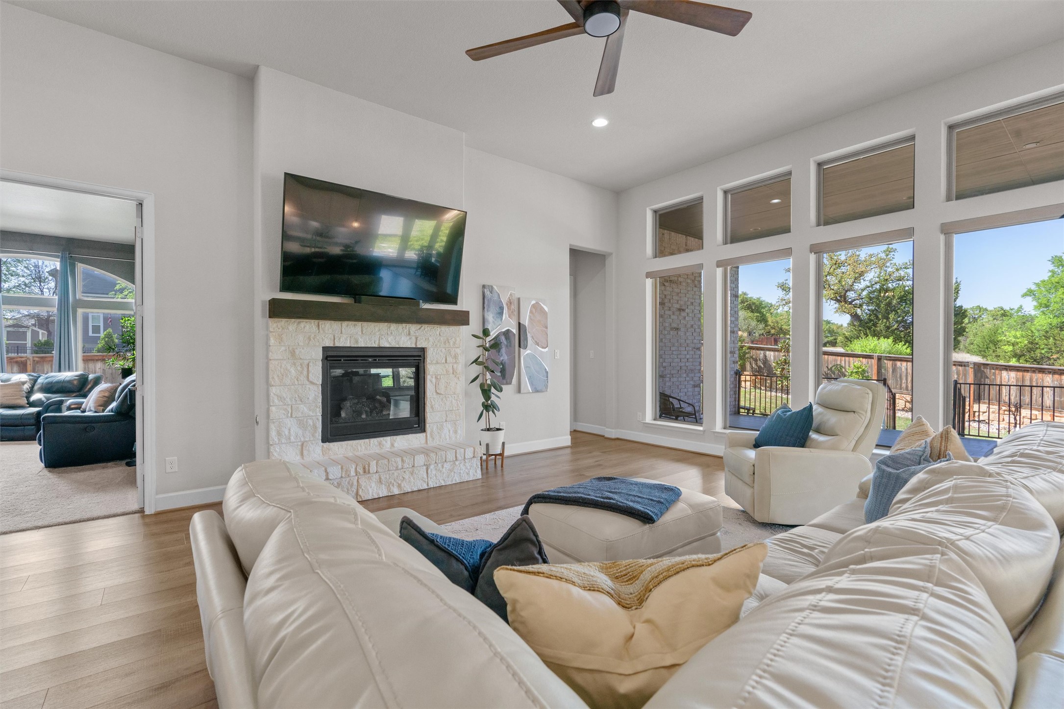 101 Pienza Drive Georgetown, TX 78628 - Photo 12 of 40 a living room with furniture a flat screen tv and a fireplace