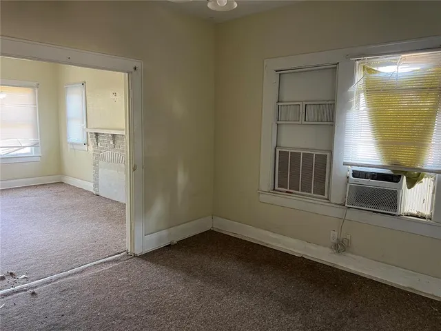 an empty room with windows and entrance
