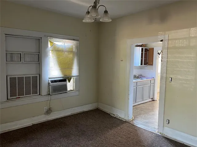a view of a livingroom with an entryway and chandelier