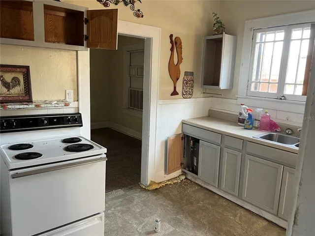 a kitchen with sink and cabinets