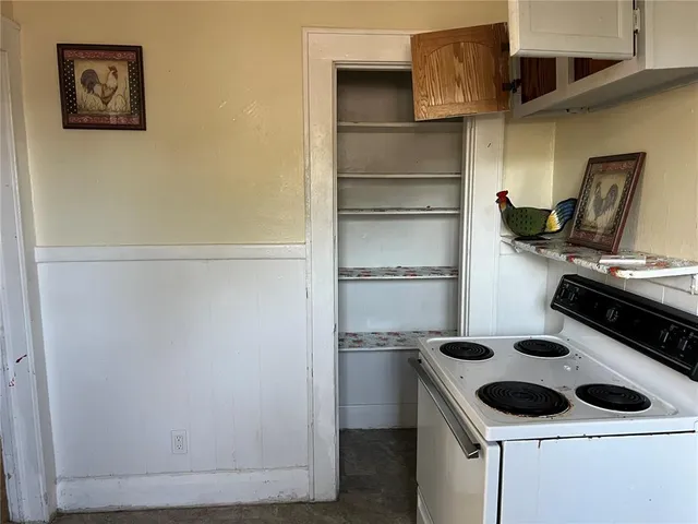 a kitchen with a refrigerator and a stove