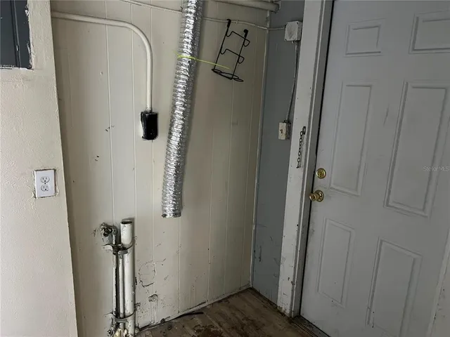 an empty room with windows and flat screen tv