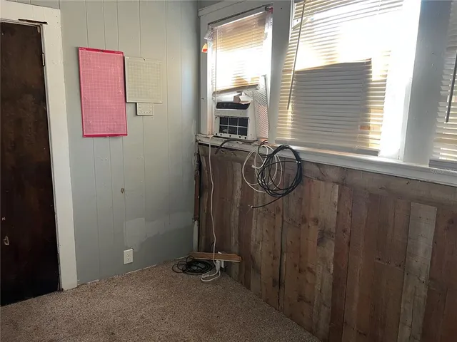 a view of backyard with wooden fence and trees