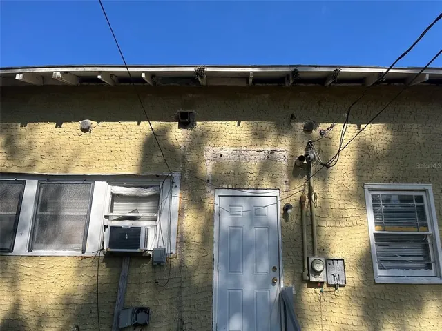 view of a brick house with a small yard