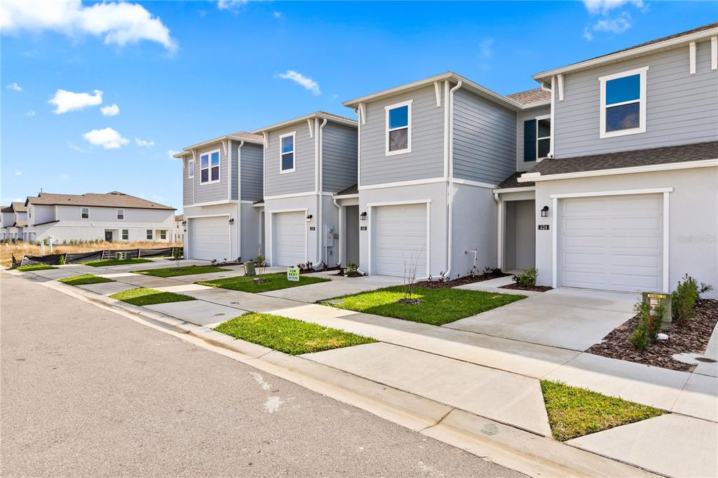 624 Poppy Lane Dundee, FL 33838 - Photo 22 of 23 a front view of a house with a yard and garage