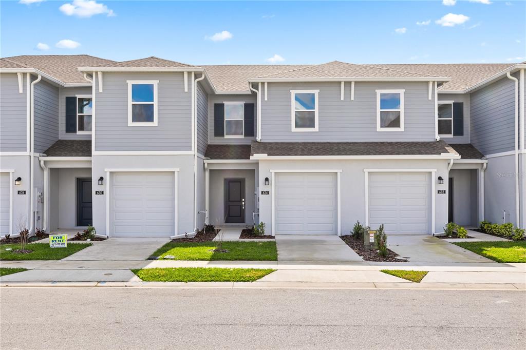 624 Poppy Lane Dundee, FL 33838 - Photo 23 of 23 a front view of a house with a yard and garage