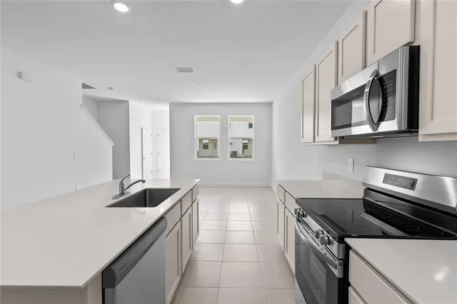 a kitchen that has a sink and a stove