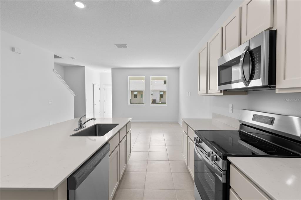 624 Poppy Lane Dundee, FL 33838 - Photo 3 of 23 a kitchen that has a sink and a stove