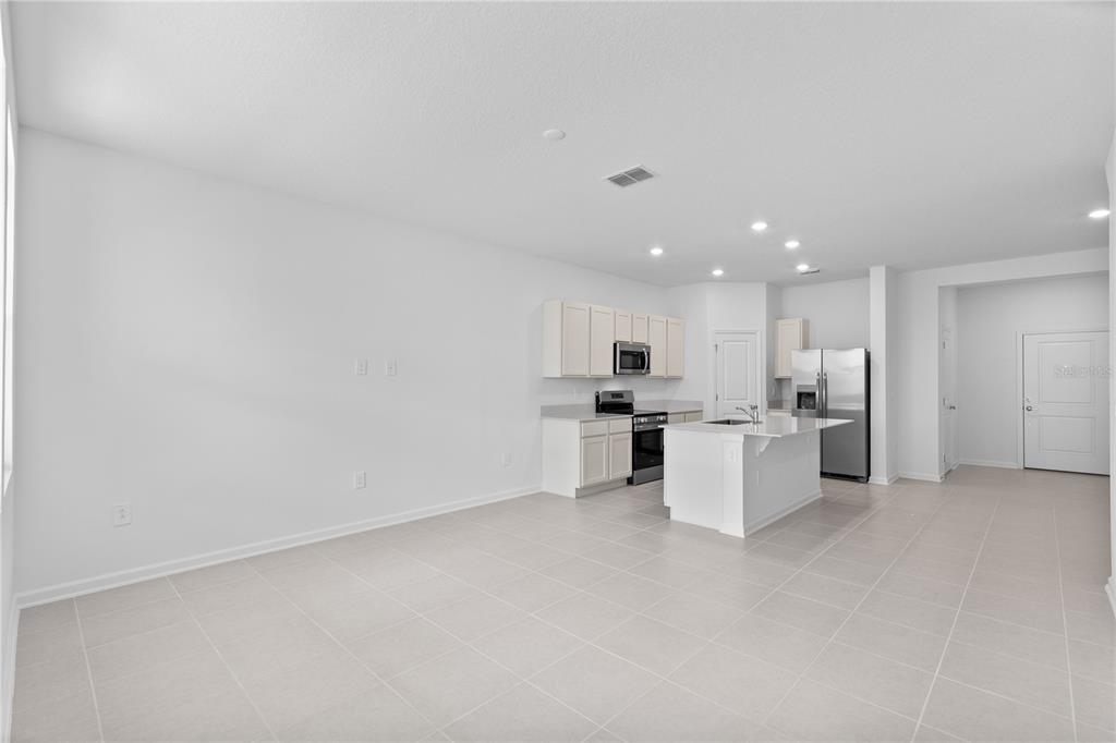 624 Poppy Lane Dundee, FL 33838 - Photo 7 of 23 a view of kitchen with white cabinets and wooden floor