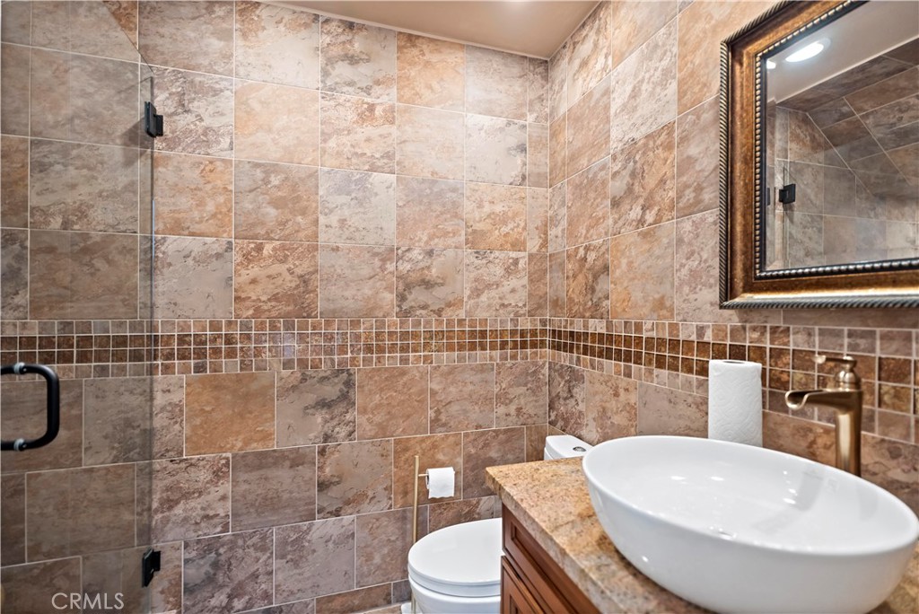 11855 Modena Drive Rancho Cucamonga, CA 91701 - Photo 13 of 30 a bathroom with a toilet a sink and mirror