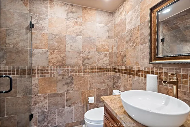 a bathroom with a toilet a sink and mirror